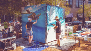 people painting a mural