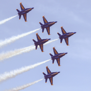 The primary 6 F-18 Super Hornets of the US Navy Blue Angels flies through the blue sky above Pensacola